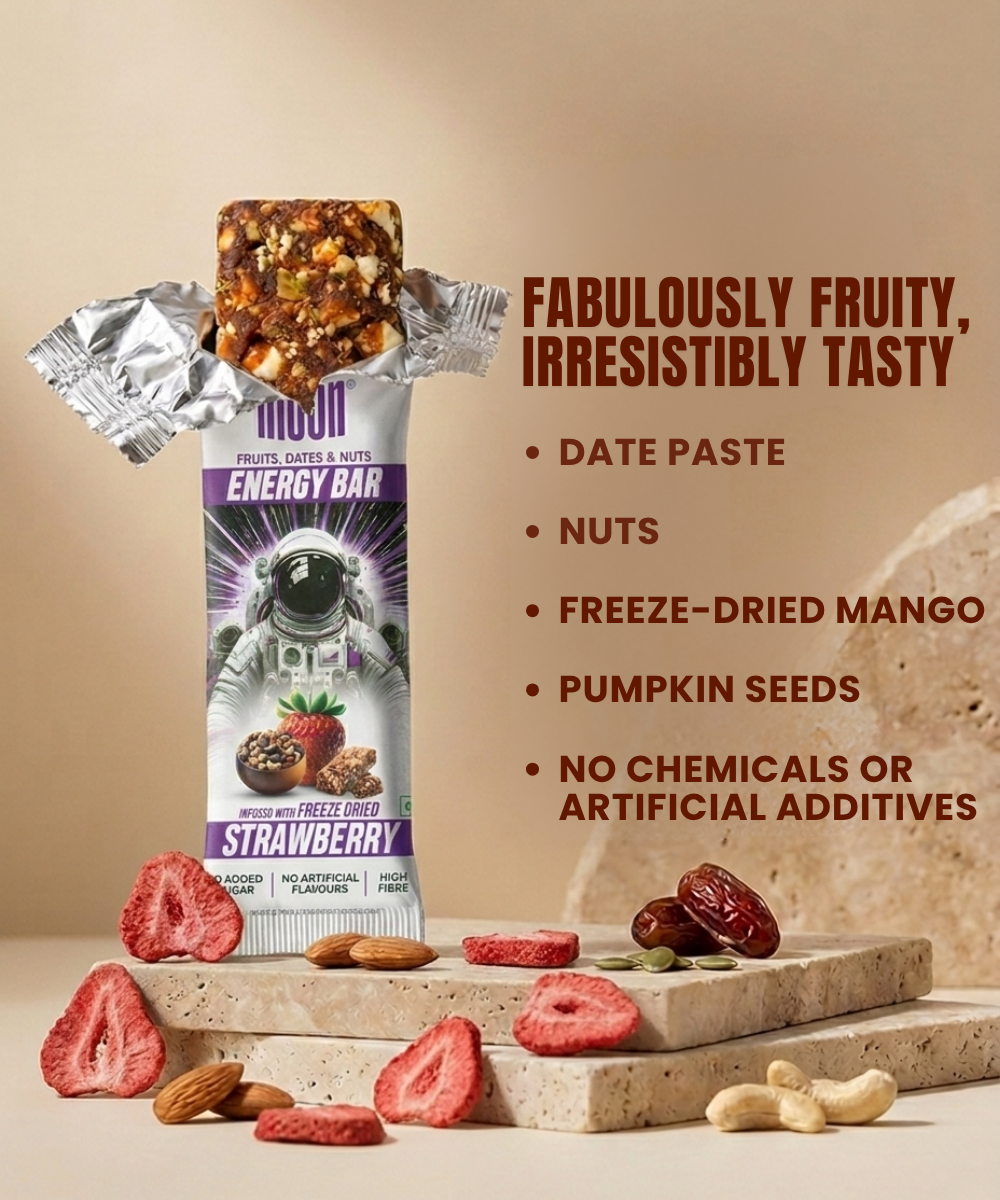A MOON Energy Bar - Strawberry by MOONFREEZE FOODS PRIVATE LIMITED sits unwrapped on stone with freeze-dried strawberries, nuts, and seeds; ingredients and benefits are listed alongside.