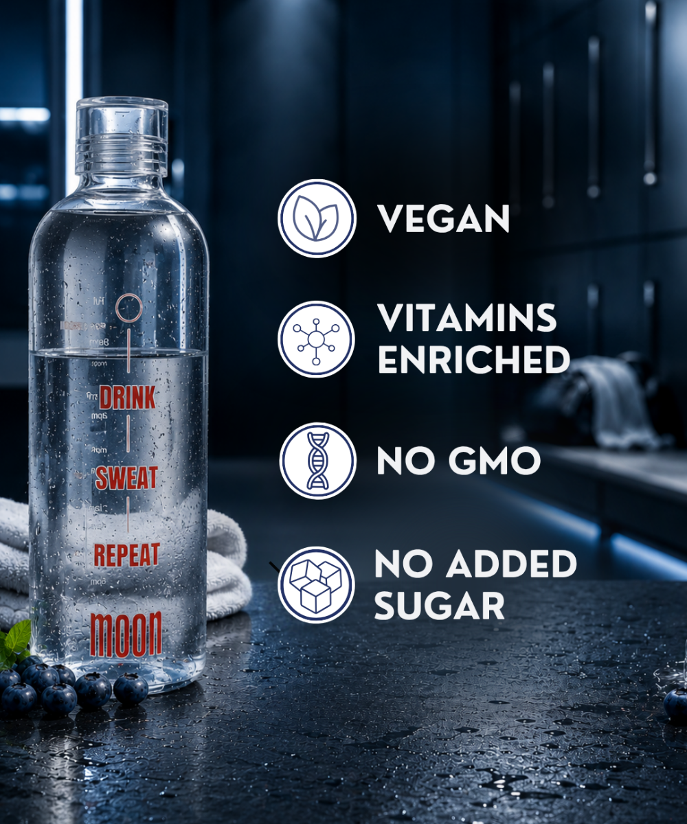 A bottle of Lunar Hydration Booster - Blueberry Flavour by MOONFREEZE FOODS PRIVATE LIMITED sits on a damp gym locker room surface, labeled as vegan, vitamin-enriched, non-GMO, no added sugar. Nearby lie towels and blueberries.
