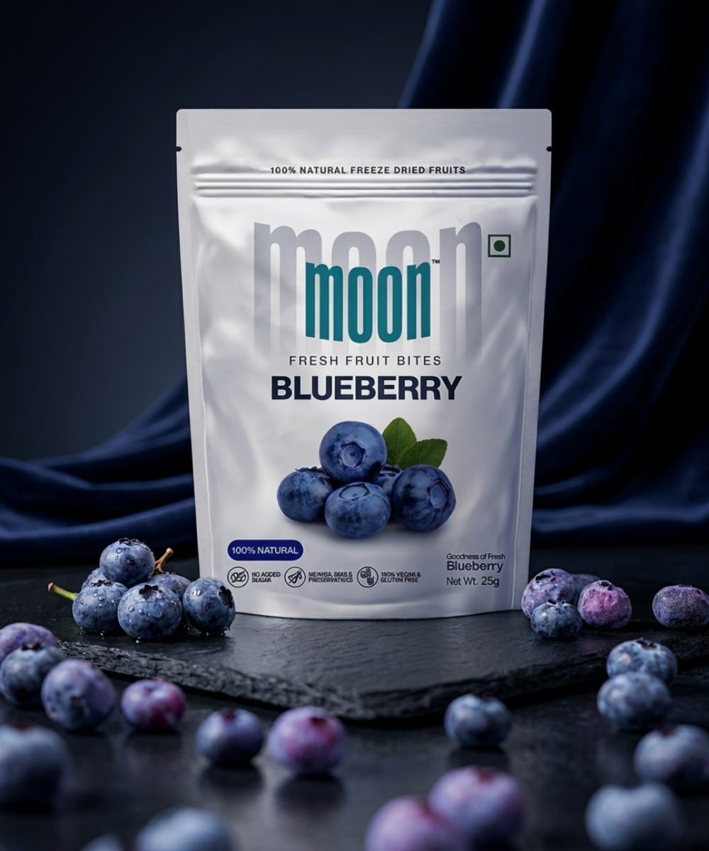 A pouch of Themoonstoreindia Moon Freeze Dried Blueberry stands upright on a dark surface, surrounded by scattered blueberries.