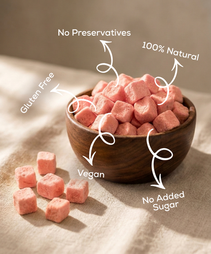 A wooden bowl holds Moon Freeze Dried Pink Guava cubes by Themoonstoreindia on a beige cloth, labeled gluten free, vegan, no preservatives, 100% natural, no added sugar, and rich in vitamin C.