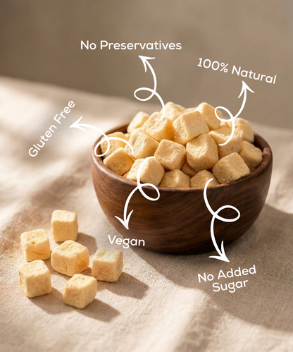 A wooden bowl holds Moon Freeze Dried Custard Apple Cubes by Themoonstoreindia, labeled gluten free, vegan, 100% natural, with no preservatives or added sugar. Some delicious cubes are scattered outside the bowl.